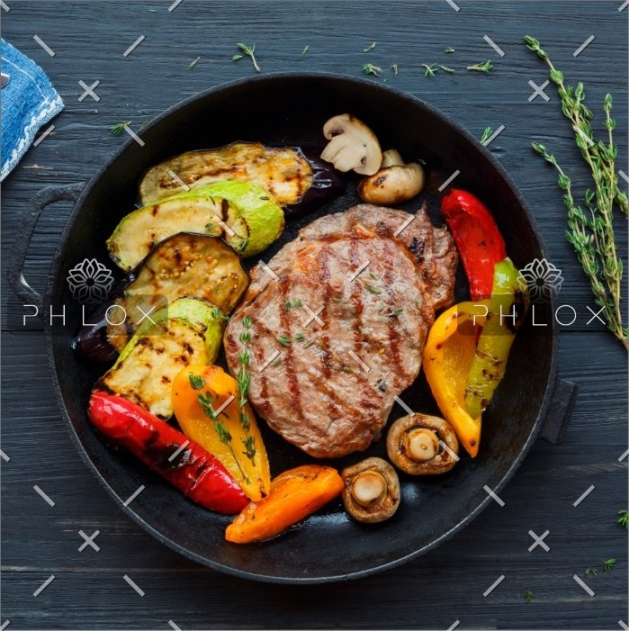 grilled-beef-steak-on-dark-wooden-table-P4NLM25