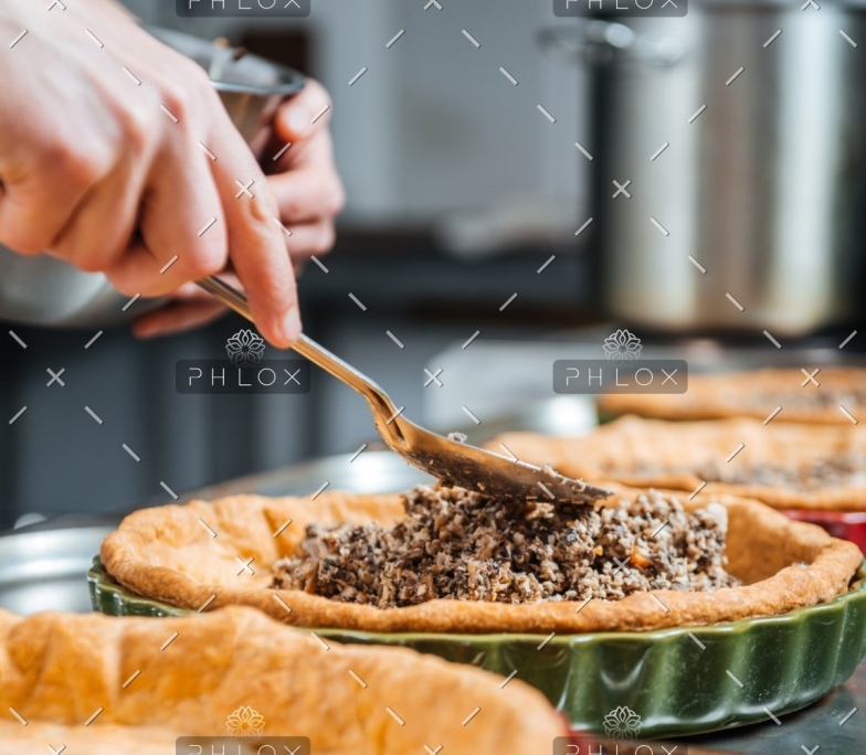 hands-of-cheif-cook-cooking-and-putting-filling-PESKNNF